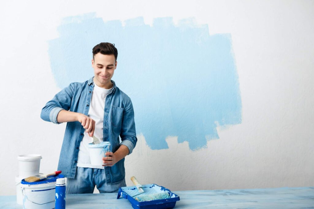 Happy guy mixes pigment for paint wall.jpg