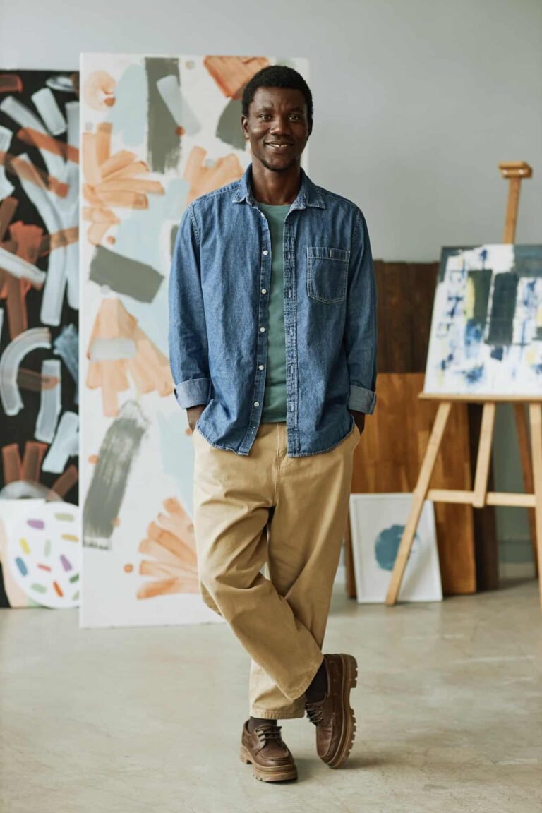 Happy young creative craftsman in casual attire standing in front of camera.jpg